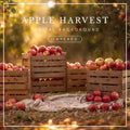 Digital background featuring wooden crates overflowing with red apples in a sunlit autumn orchard, with scattered apples, a soft blanket, and warm golden foliage.